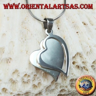 Silver pendant with two hearts, one of which is pierced