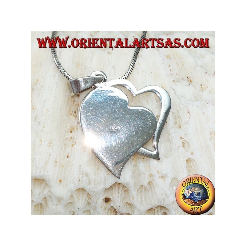 Silver pendant with two hearts, one of which is pierced