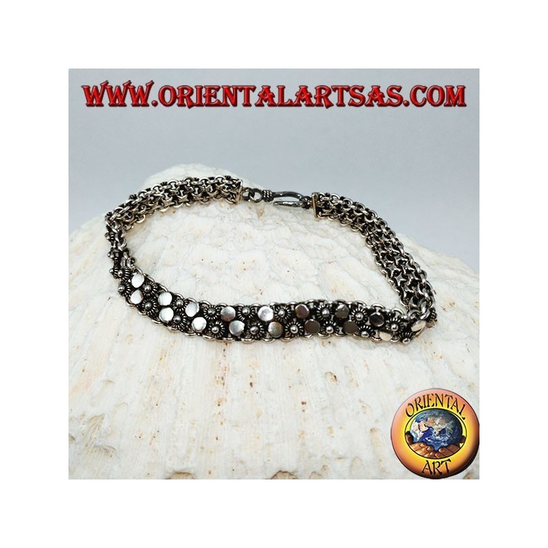 Silver bracelet with two rows of small flowers and round plates