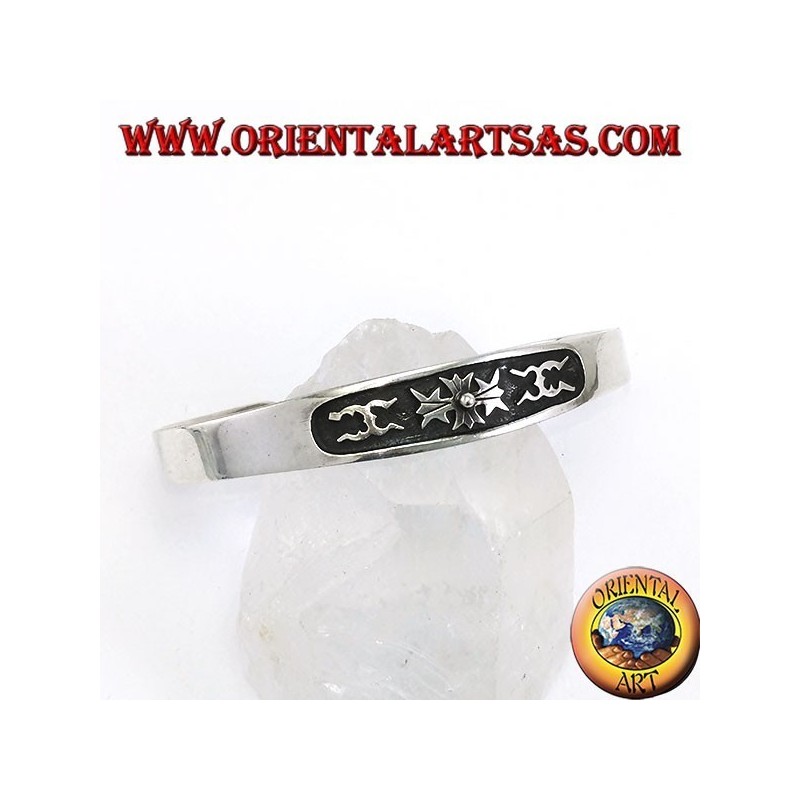 Silver cuff bracelet with central low relief carving