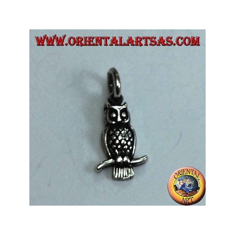 Silver pendant owl on the curved branch