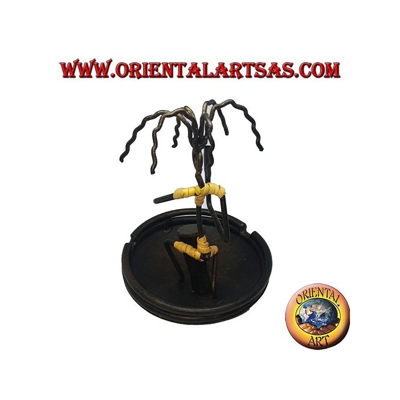 Burning incense, wrought iron ashtray, the percussionist