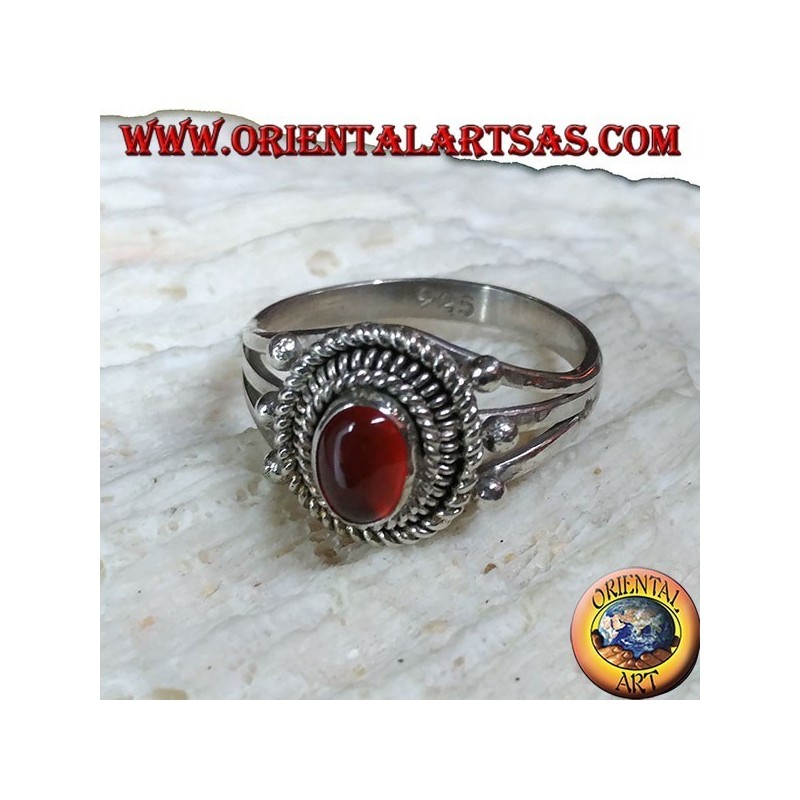 Silver ring with carnelian cabochon surrounded by three serpentine threads