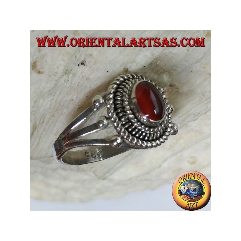 Silver ring with carnelian cabochon surrounded by three serpentine threads