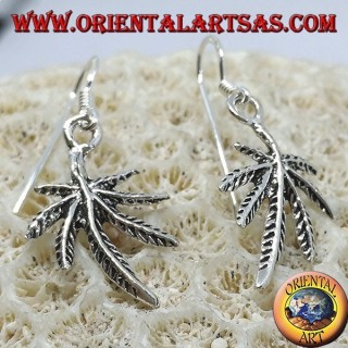 Silver earrings in the shape of marijuana leaf