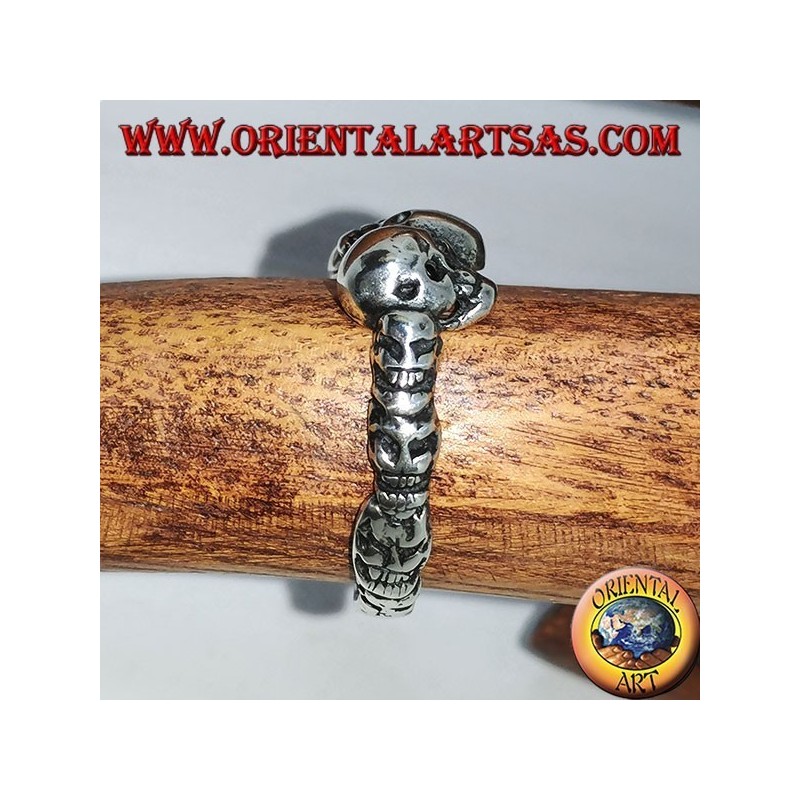 Silver ring with three skulls with bone