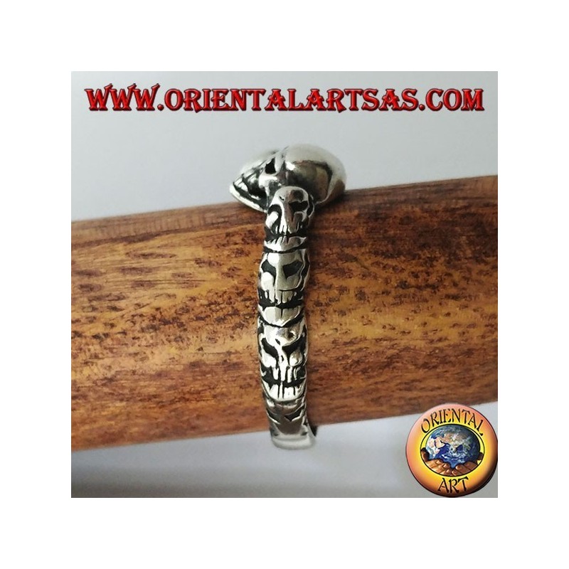 Silver ring with three skulls with bone