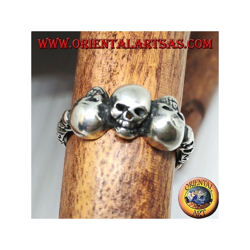 Silver ring with three skulls with bone