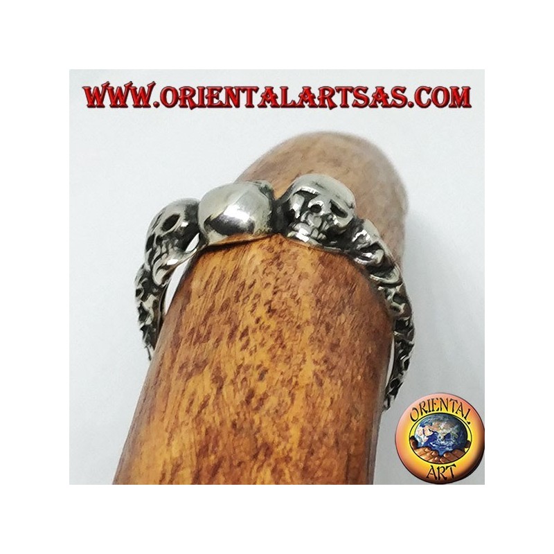 Silver ring with three skulls with bone