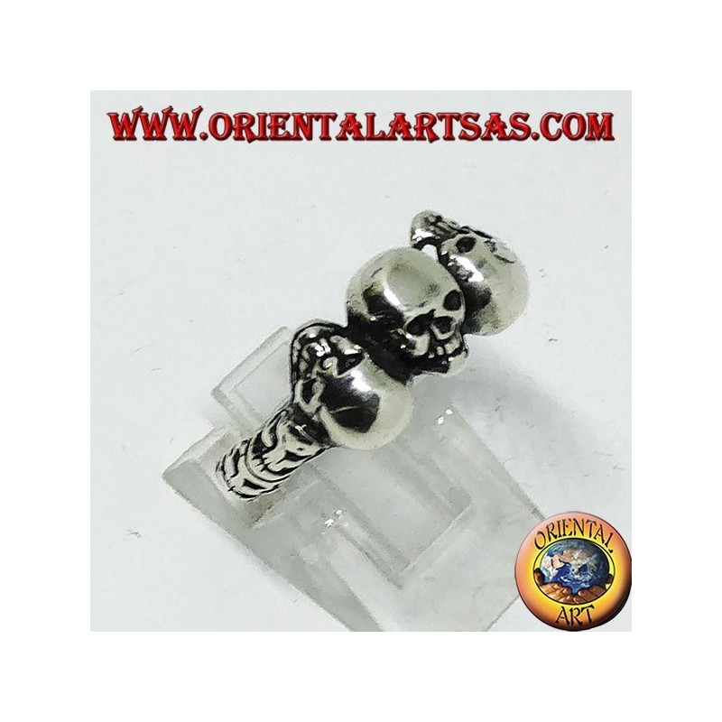 Silver ring with three skulls with bone