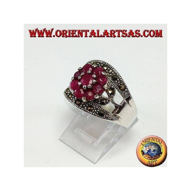 Silver band ring with a flower set with 9 round rubies set