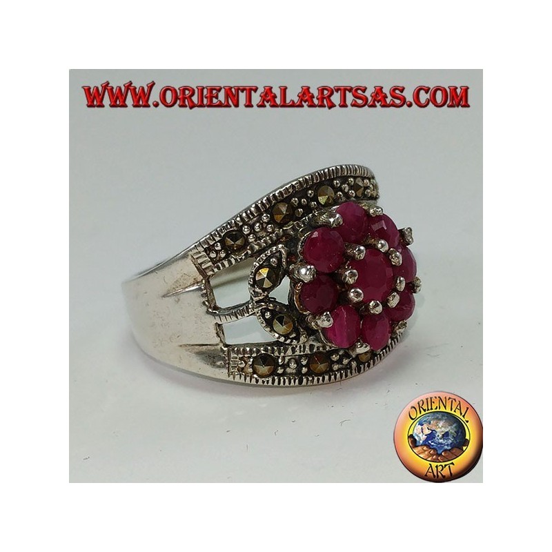 Silver band ring with a flower set with 9 round rubies set