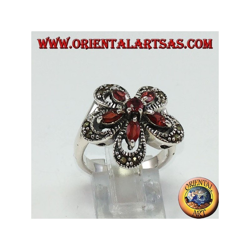 Anillo de plata con forma de flor con 5 granates lanzadera y una ronda central.
