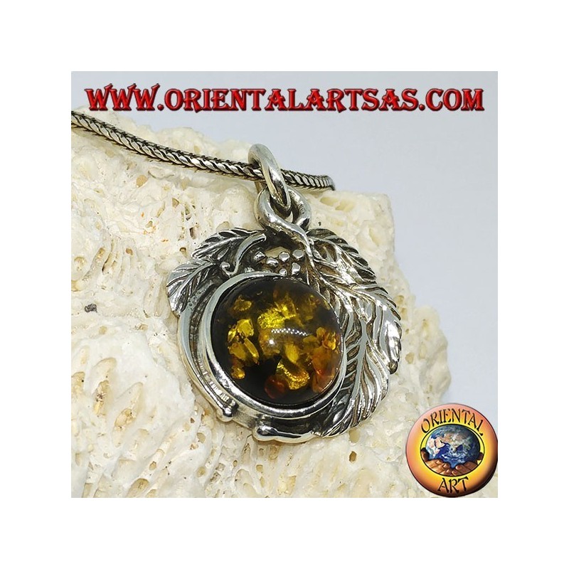 Silver pendant with a hemispherical amber between the leaves