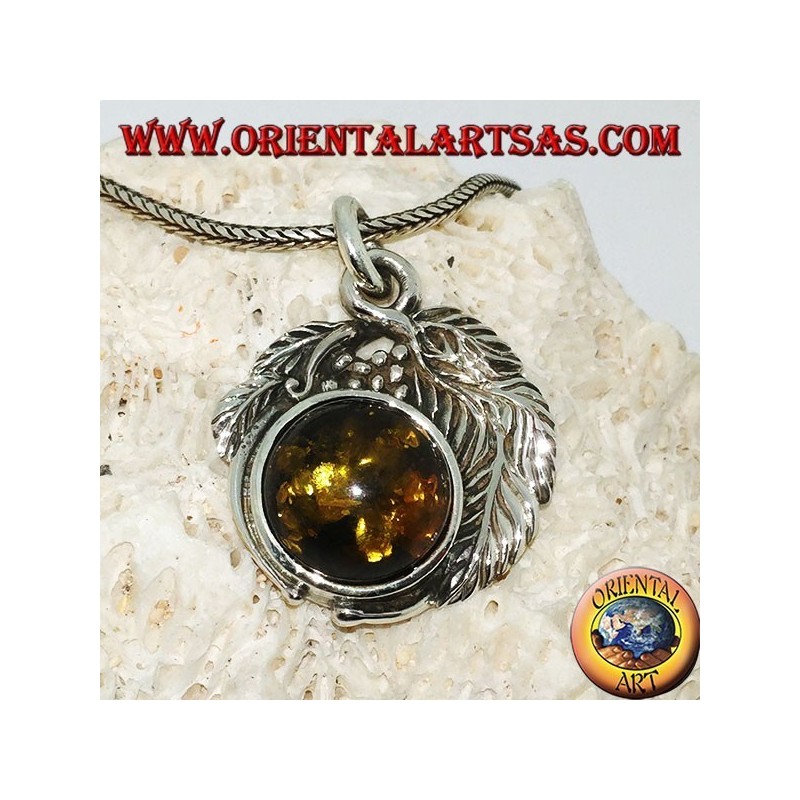 Silver pendant with a hemispherical amber between the leaves