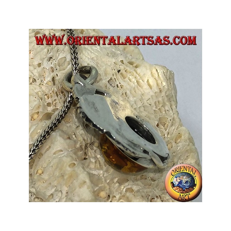 Silver pendant with a hemispherical amber between the leaves