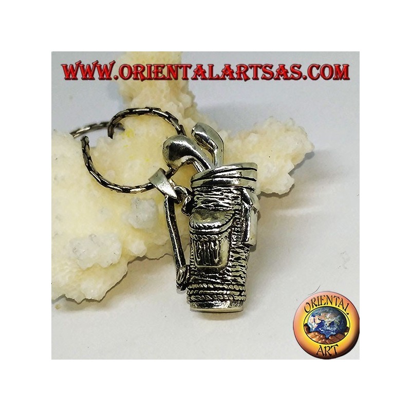 Silver pendant, golf bag with clubs