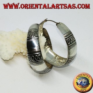 Silver earrings with a round wide-rimmed ring with transverse wave decoration