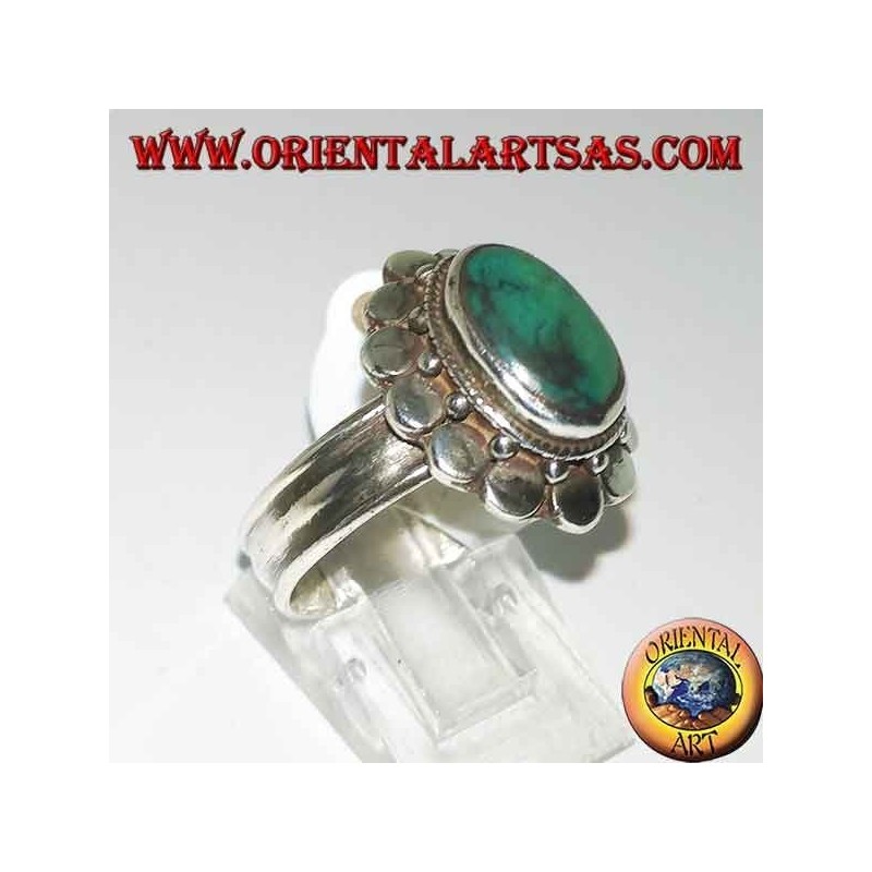 Silver ring with natural antique oval turquoise, edged with round plates