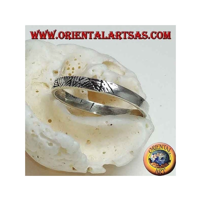 Anillo de banda en plata estrecha con incisiones geométricas.