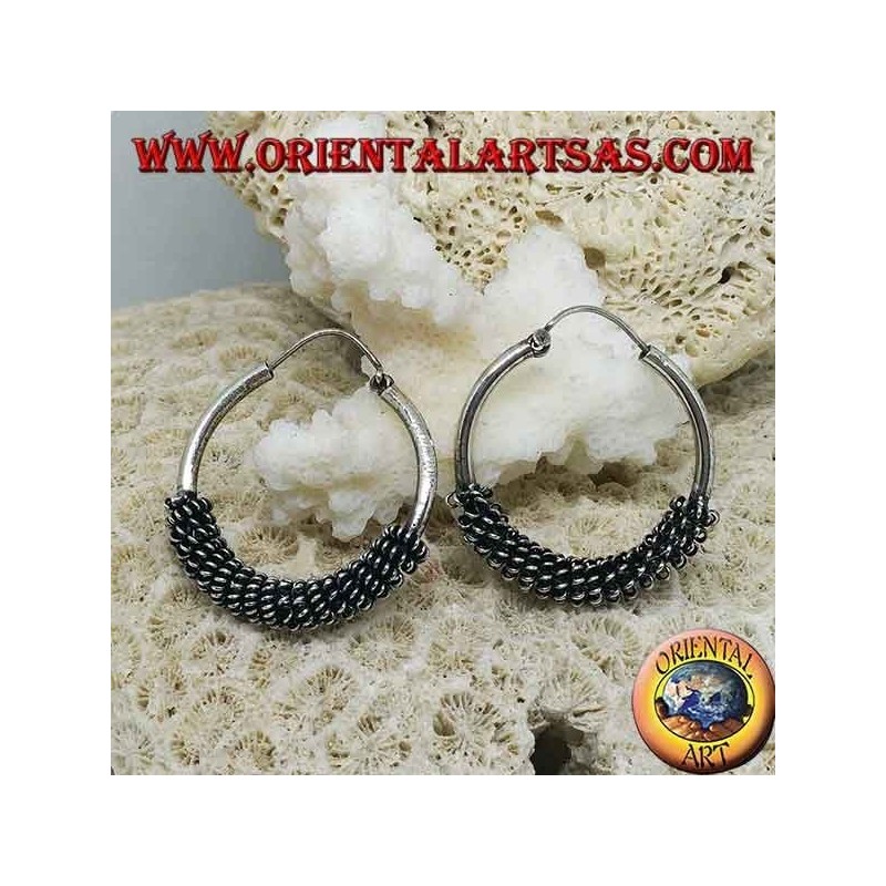 Silver hoop earrings twisted into a spiral