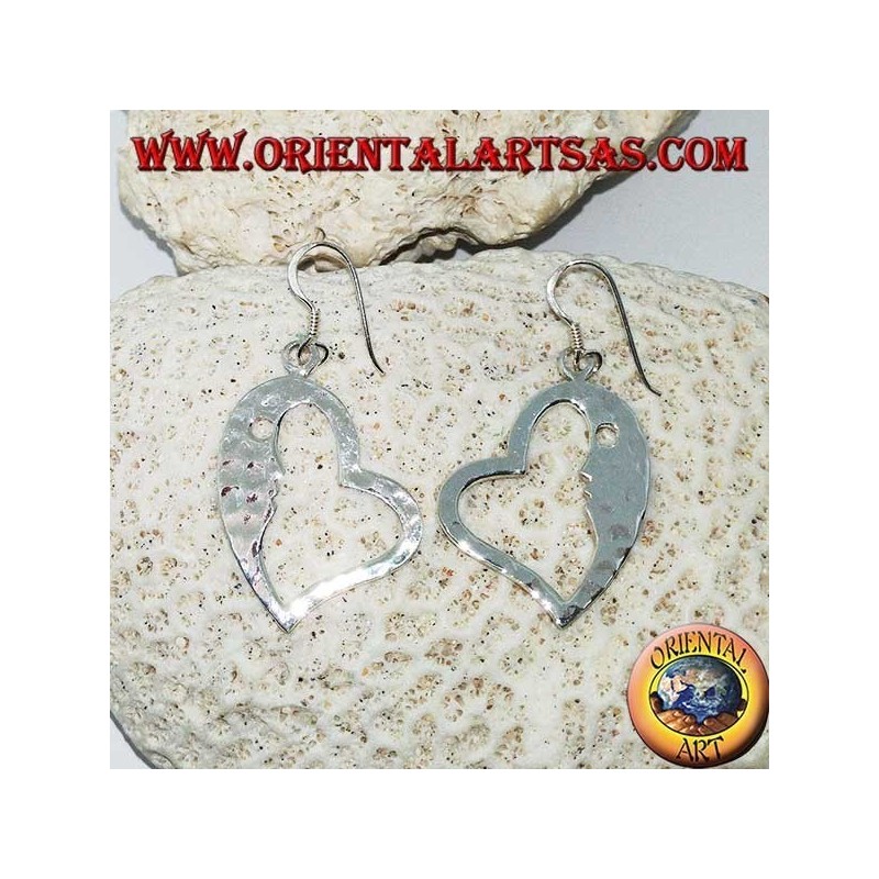 Hammered silver heart-shaped earrings with a striking face on the inside