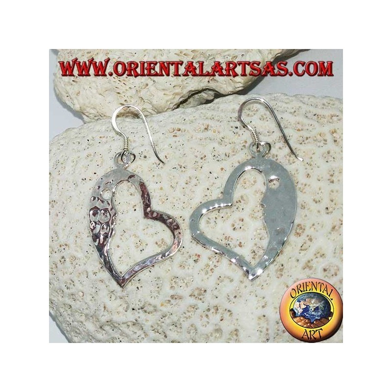 Hammered silver heart-shaped earrings with a striking face on the inside