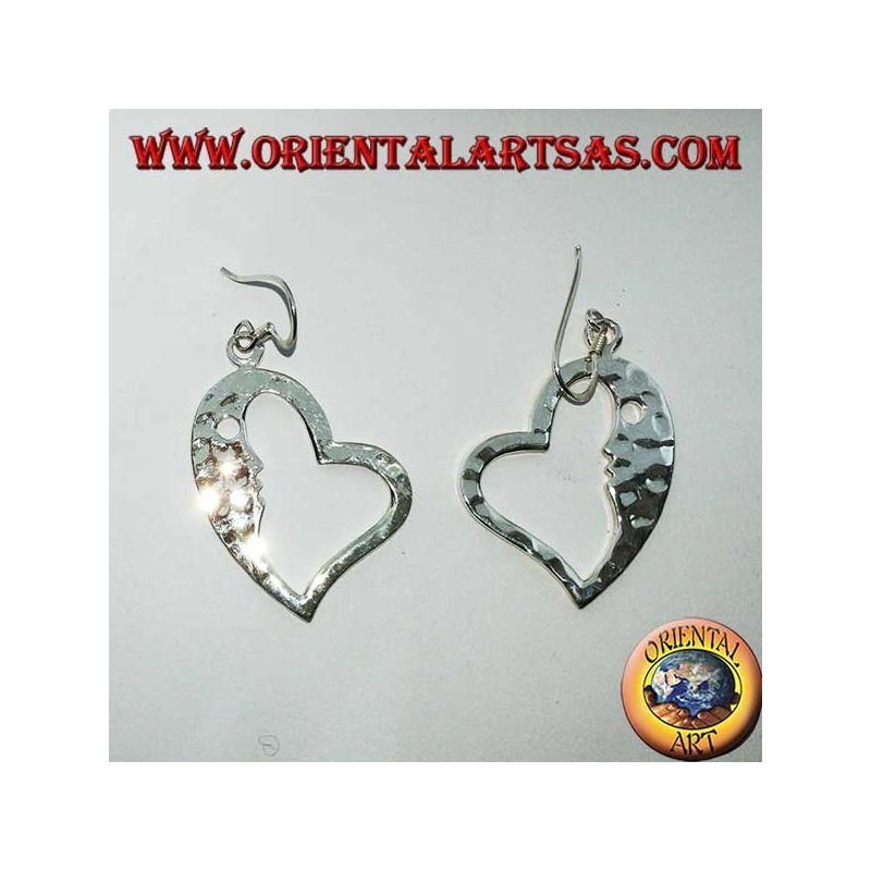 Hammered silver heart-shaped earrings with a striking face on the inside