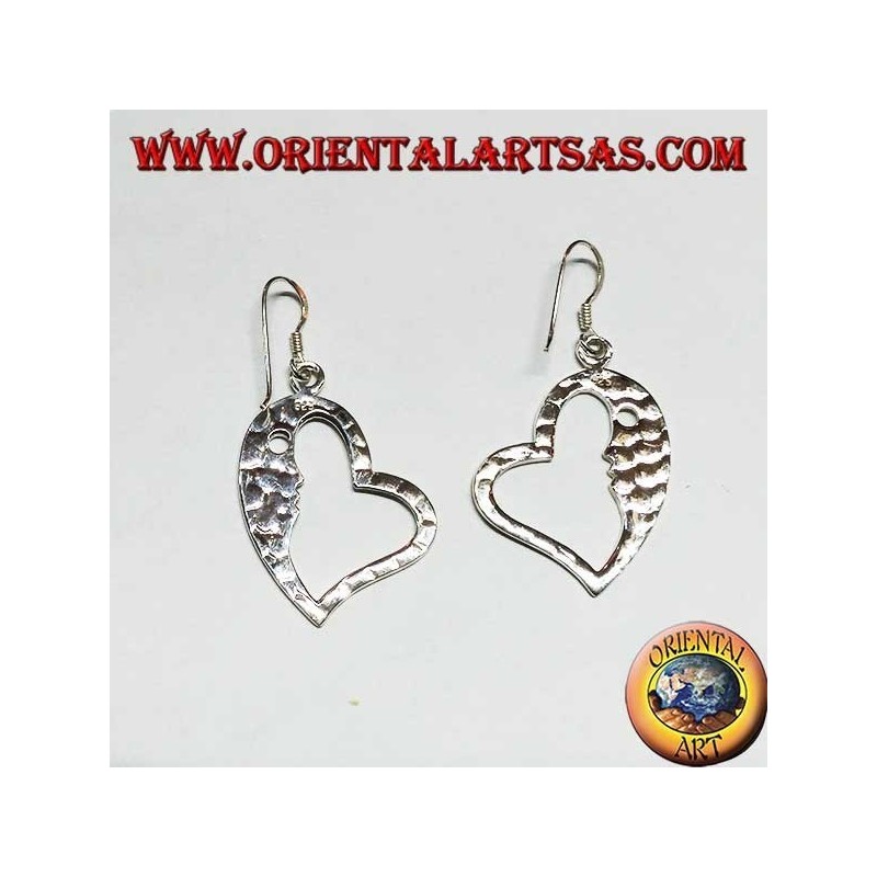 Hammered silver heart-shaped earrings with a striking face on the inside