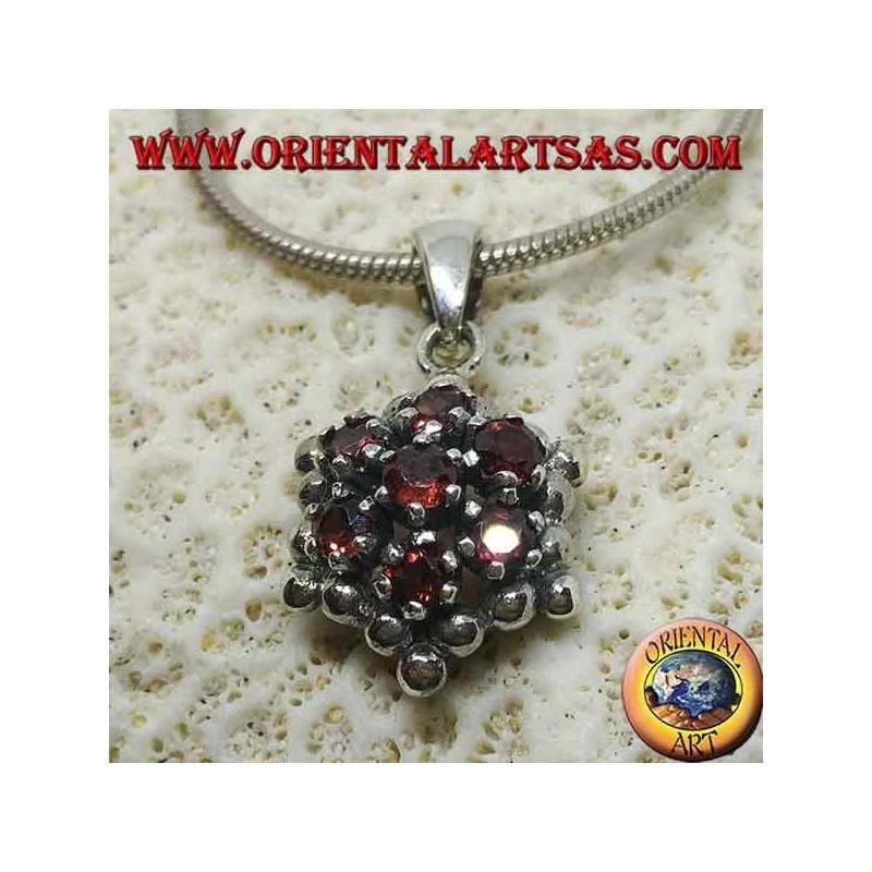 Hexagonal silver pendant made up of 7 round garnets surrounded by silver spheres