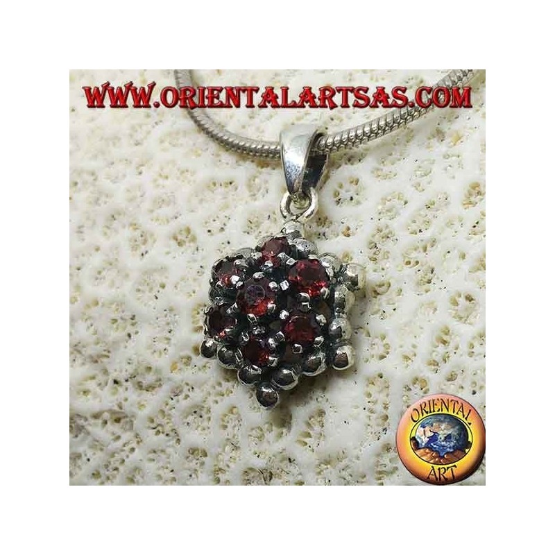 Hexagonal silver pendant made up of 7 round garnets surrounded by silver spheres