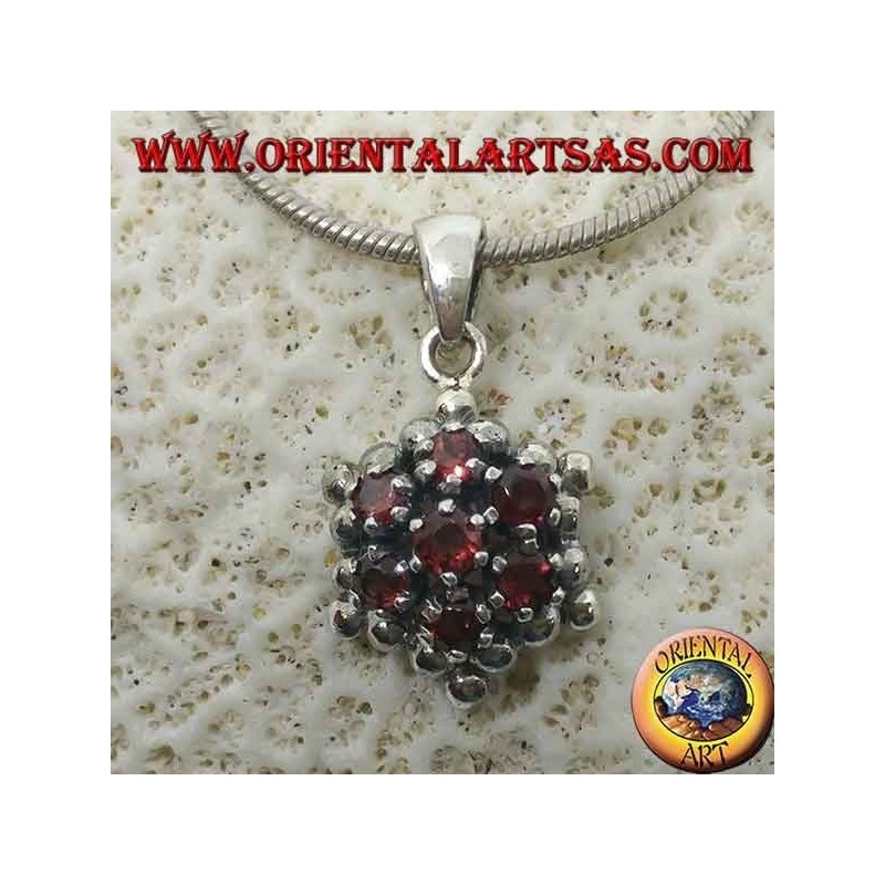 Hexagonal silver pendant made up of 7 round garnets surrounded by silver spheres