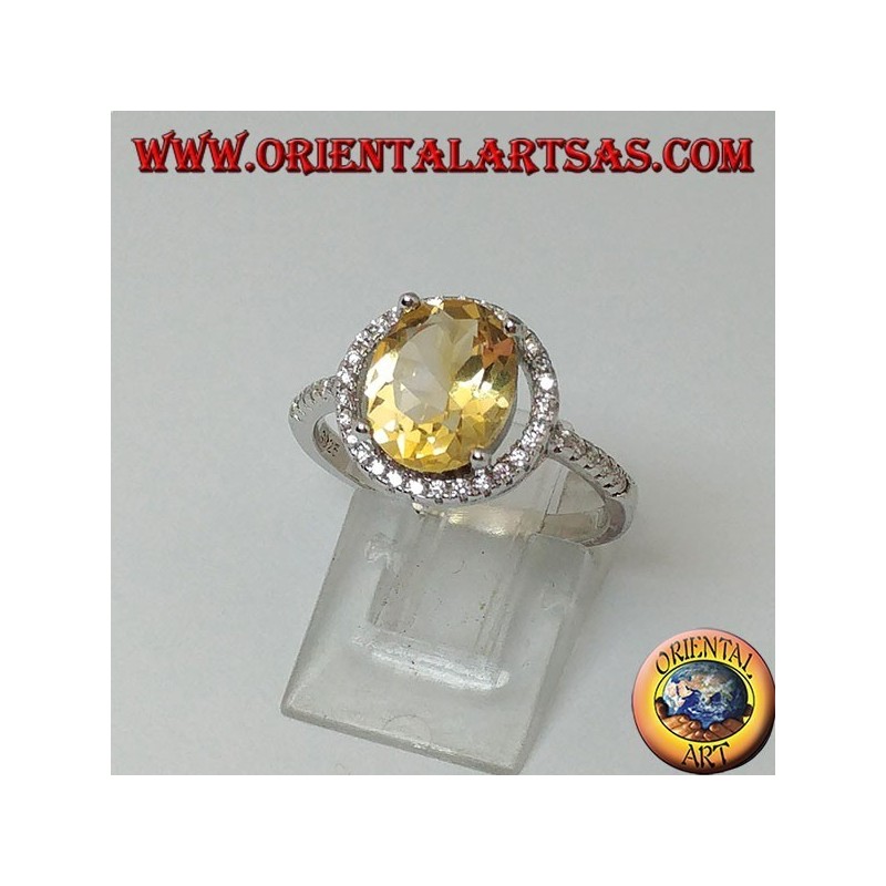 Silver ring with natural topaz suspended on a circle of zircons