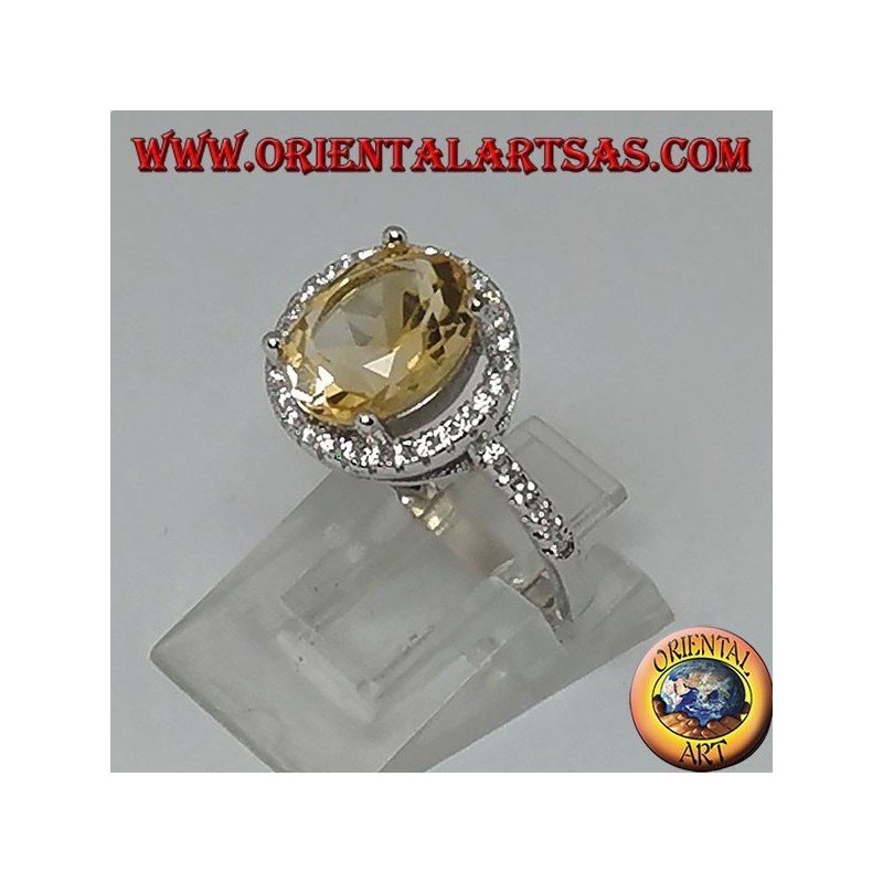 Silver ring with natural topaz suspended on a circle of zircons