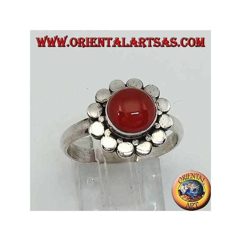Silver ring with a round cabochon carnelian surrounded by studs
