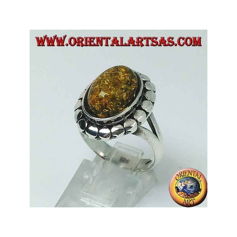 Silver ring with green oval amber surrounded by studs