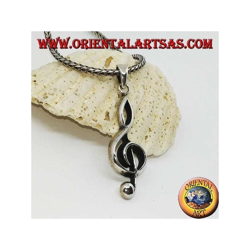 silver pendant treble clef or key of a large sun