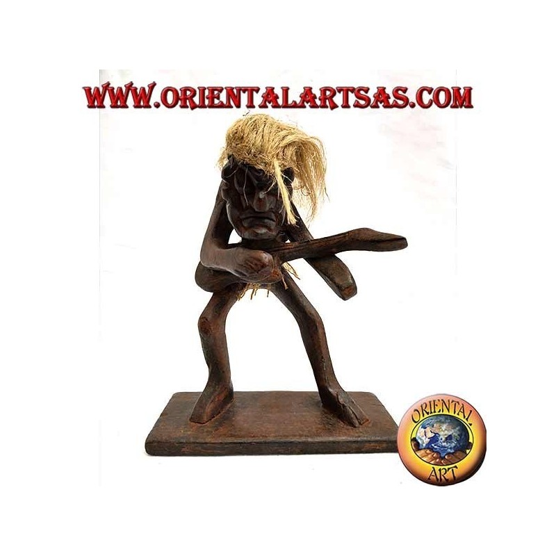 Sculpture of a primitive man guitarist in teak wood