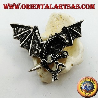 Silver dragon pendant with spread wings and dagger between the claws