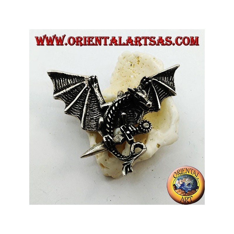 Silver dragon pendant with spread wings and dagger between the claws