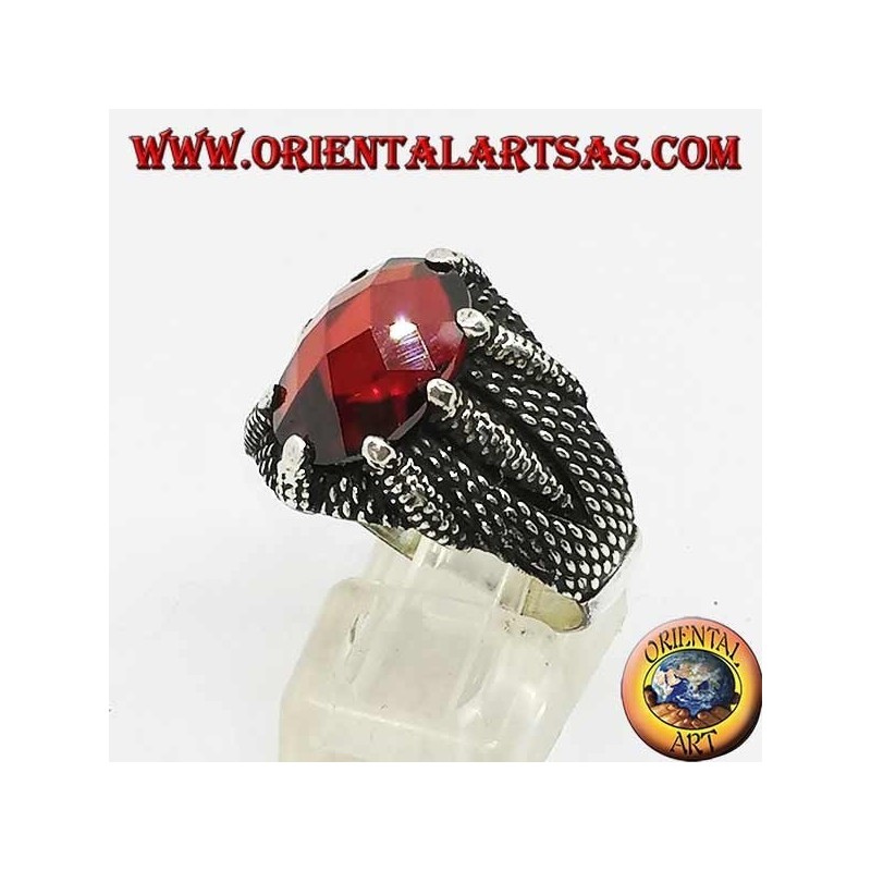 Silver ring with oval faceted garnet set by the claws