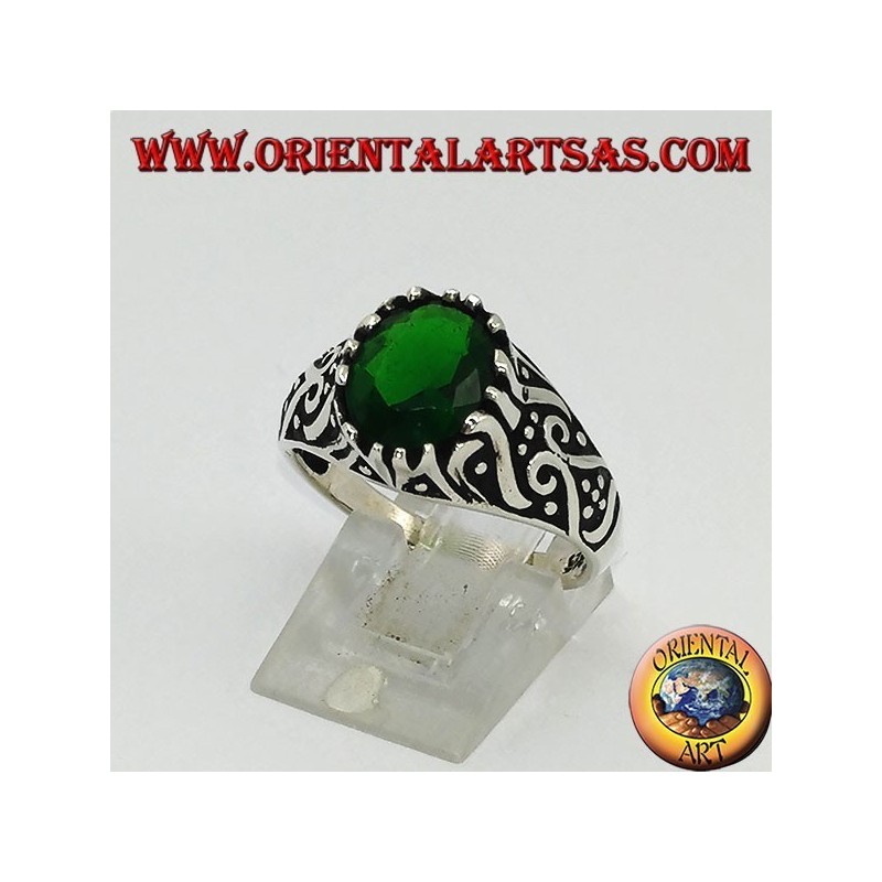 Silver ring with oval emerald zircon and high relief decorations on the sides