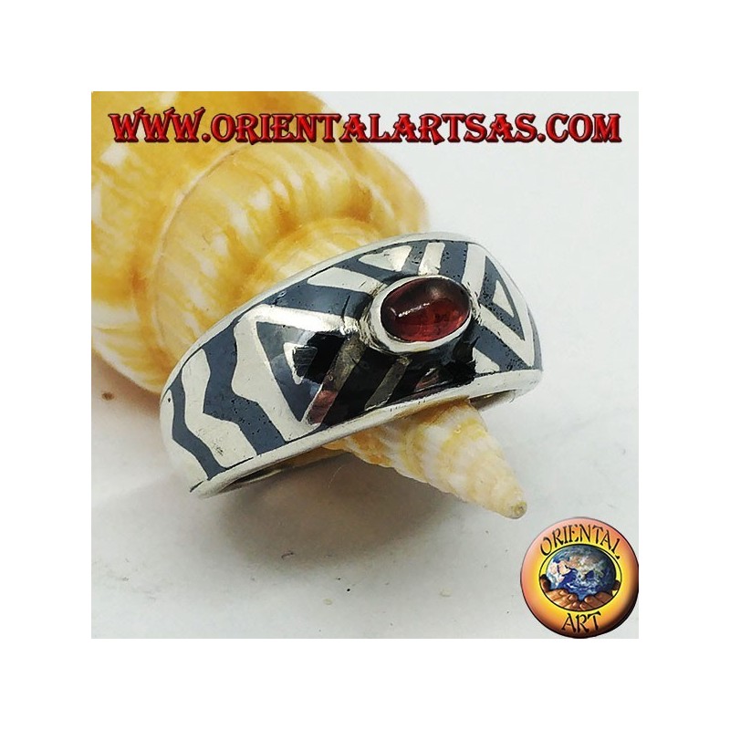 Rounded silver ring with oval garnet and niello decoration