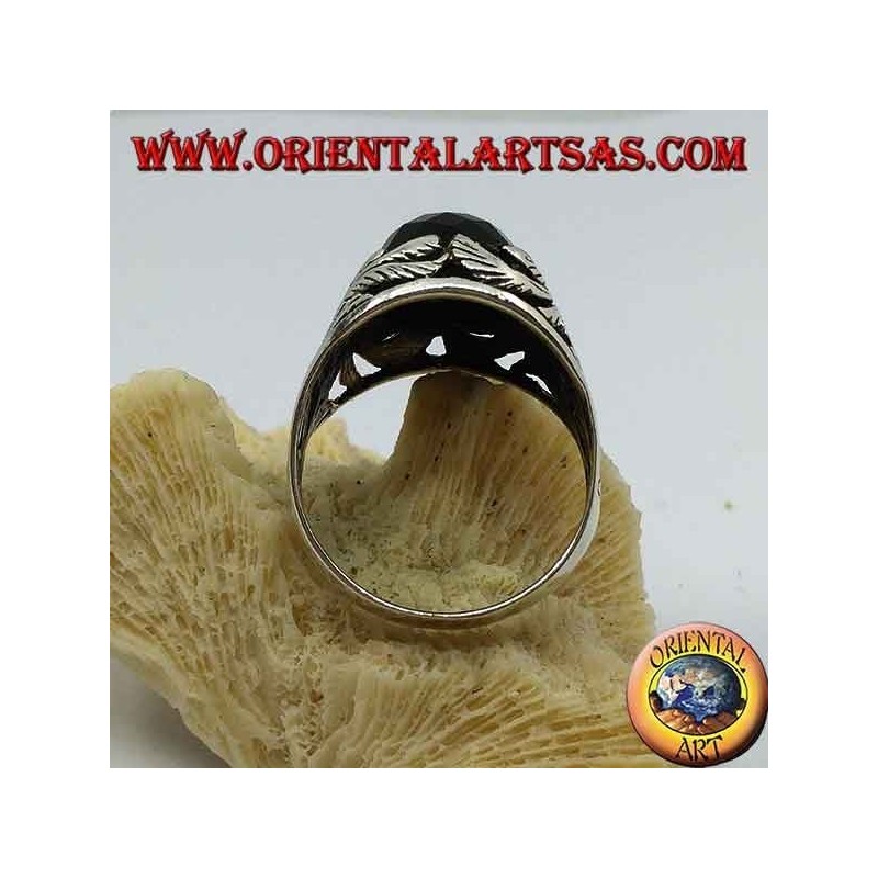 Silver ring with faceted rectangular onyx and openwork floral decorations