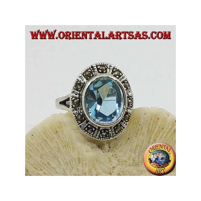 Large oval silver ring with blue topaz surrounded by marcasite