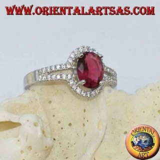 Silver ring with synthetic oval ruby set surrounded by a row of double cubic zirconia