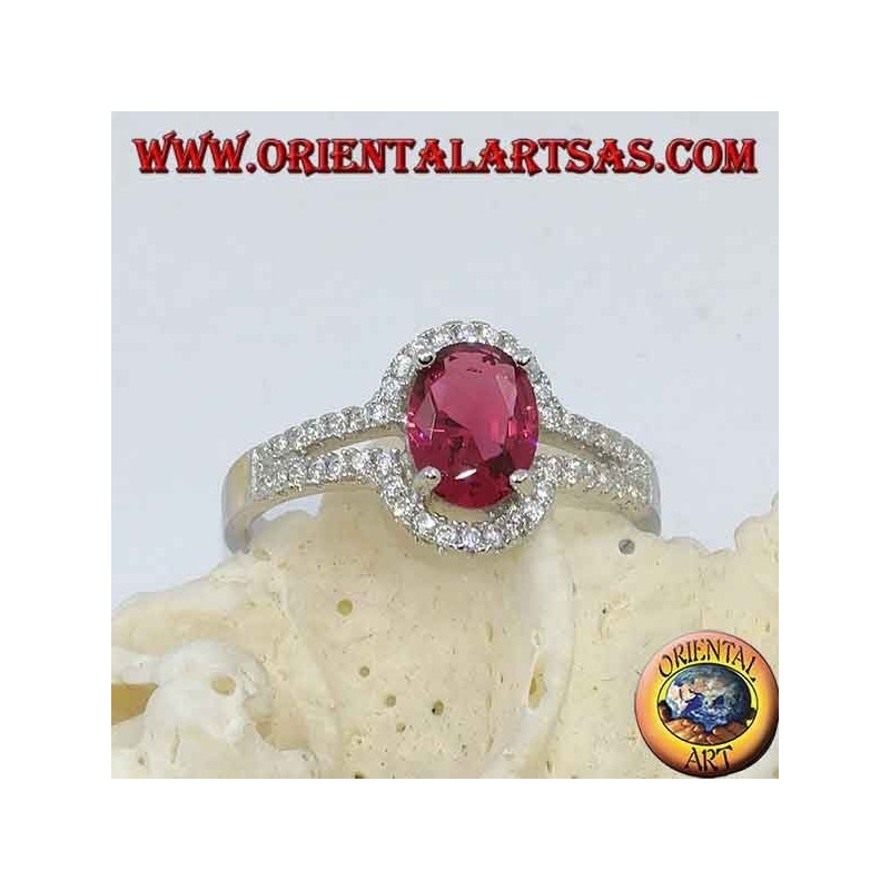 Silver ring with synthetic oval ruby set surrounded by a row of double cubic zirconia