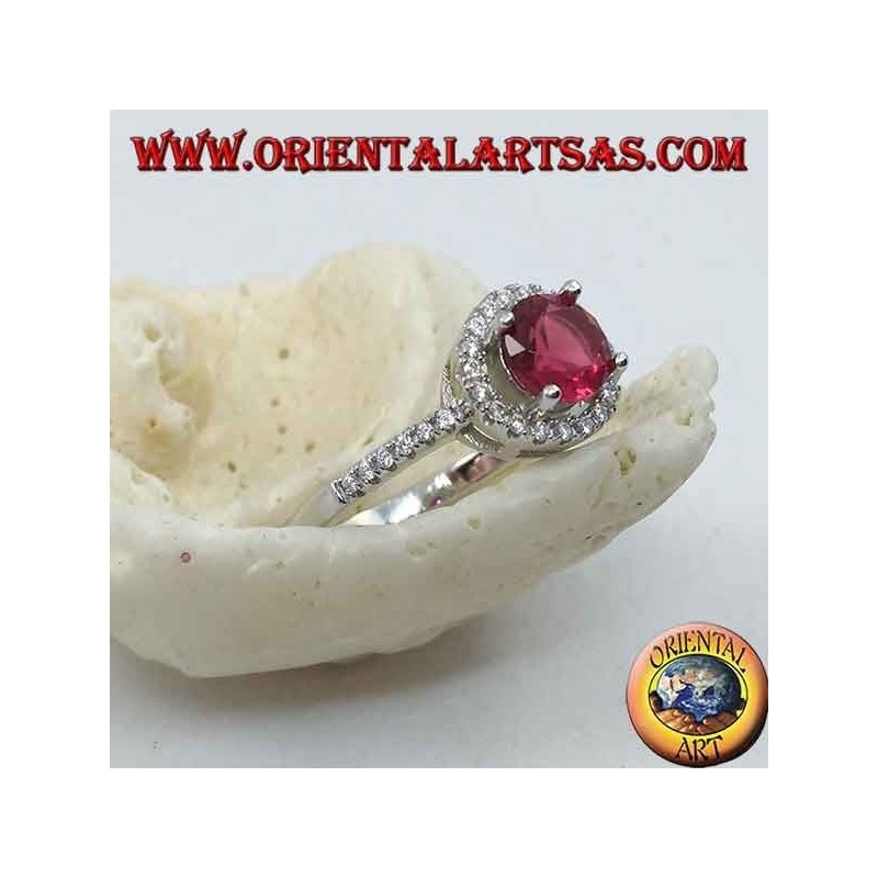 Silver ring with synthetic round ruby set surrounded by a row of zircons