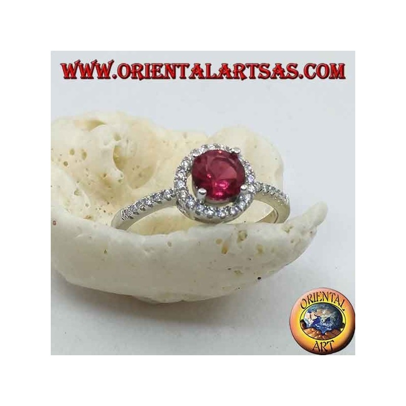 Silver ring with synthetic round ruby set surrounded by a row of zircons