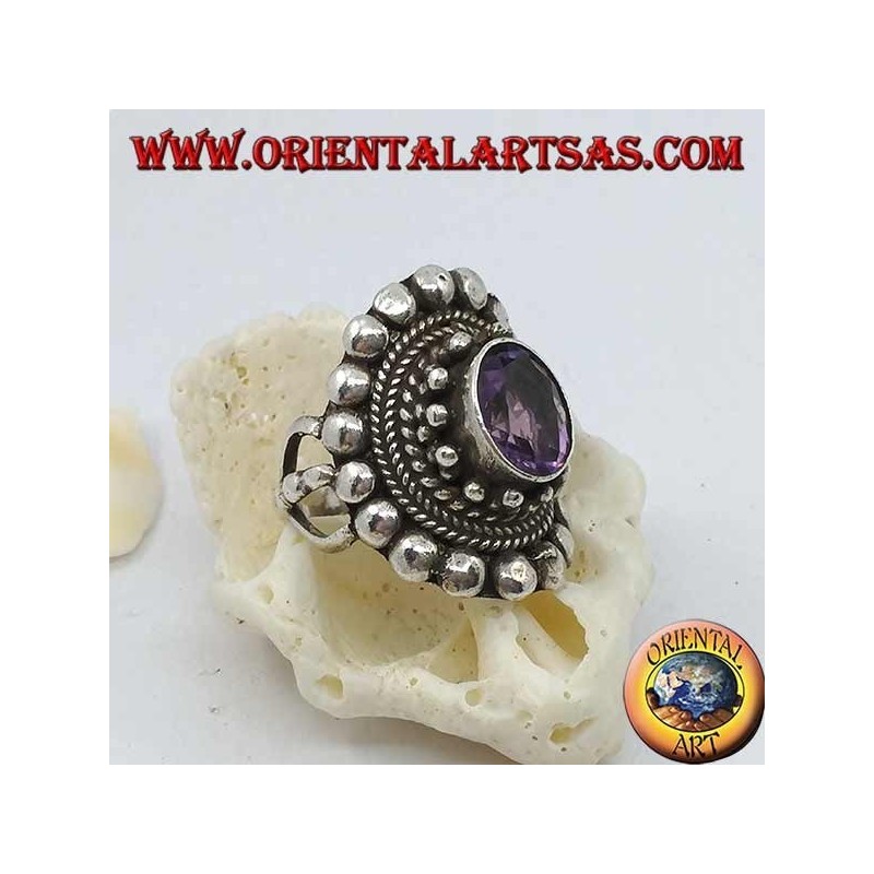 Silver ring with natural oval amethyst on a Nepalese style frame with disks and plaits